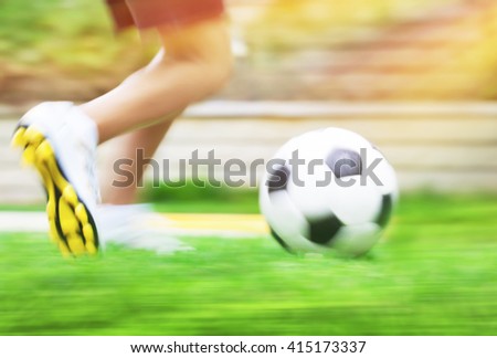 Football game slow motion, body part, sportive teen boy runs for ball, soccerl championship, active teens lifestyle, recreation and hobby