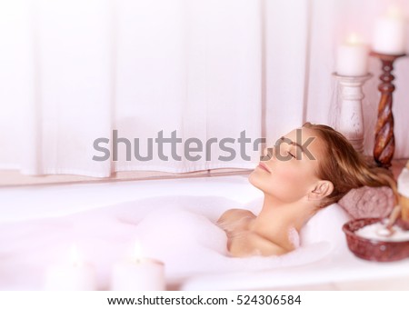 Calm women in the spa, beautiful woman with closed eyes, lying in the bath with foam, enjoying Dayspa at luxury resort