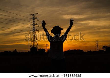 golden sky sunset with electric transmission tower and human shadow