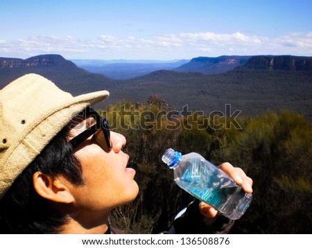 a man drinking water at Blue mountain national park Sydney
