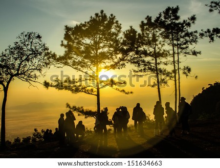 Sunrise on the mountain view with a group of people.