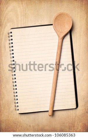 blank recipe book with wooden spoon