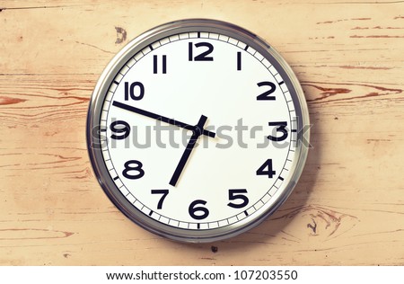 retro wall clock on old wooden background