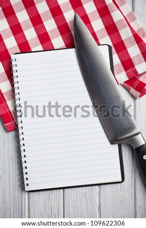the blank recipe book with kitchen knife