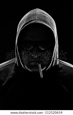 Low key portrait of a man with cigarette. studio shot.