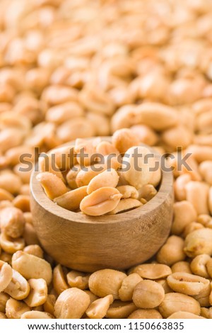 Salted roasted peanuts in bowl.