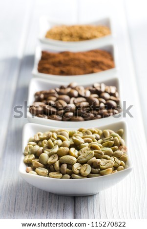 green, roasted, ground and instant coffee in ceramic bowls