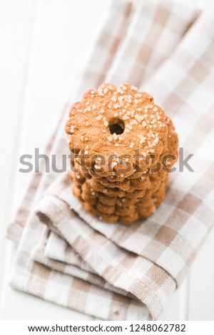 Christmas biscuits with sugar crystals on checkered napkin.