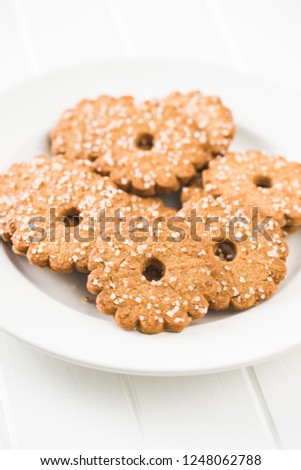 Christmas biscuits with sugar crystals on plate.