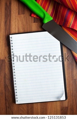 the blank recipe book and kitchen knife