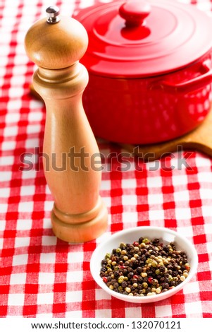 pepper and wooden pepper mill on kitchen table