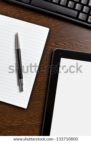 touch tablet and blank paper on office table