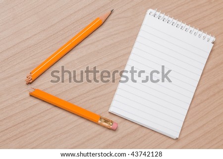 broken pencil and notepad