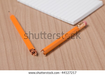 broken pencil and notepad