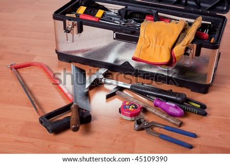 tools in tool box on wooden floor