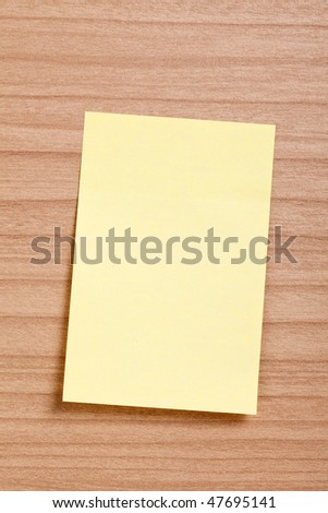 yellow note paper on wooden background