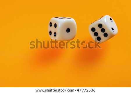 two dice on orange background