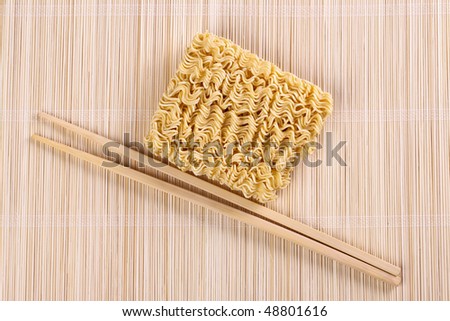 dried chinese noodles and chopsticks on table
