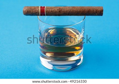 alcohol and cigar on blue background