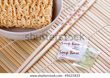 dried chinese noodles and chopsticks on table