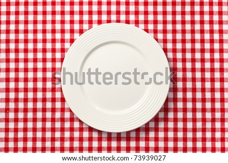 the white plate on checkered tablecloth