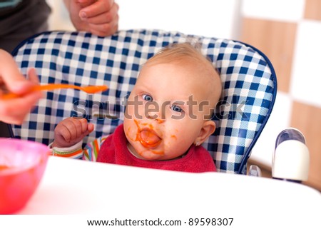 the photo shot of feeding baby food to baby