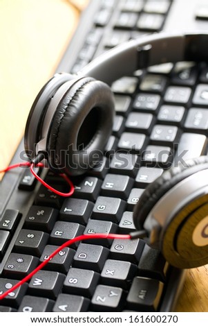 close up of headphones with keyboard