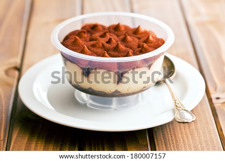 dessert tiramisu in cup on kitchen table