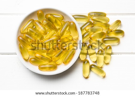 Cod liver oil. Gel capsules in bowl
