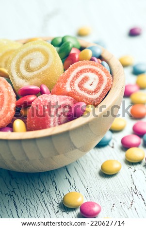 colorful candy in wooden bowl