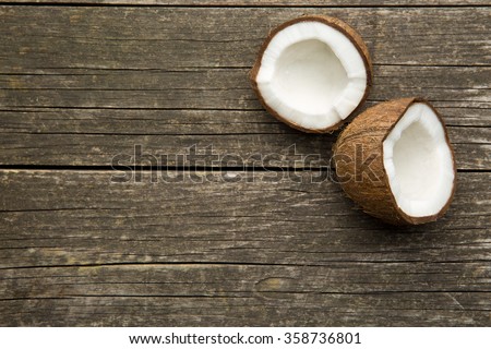 the halved coconut on old wooden background