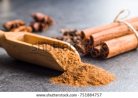 Cinnamon sticks and milled cinnamon spice on old table.