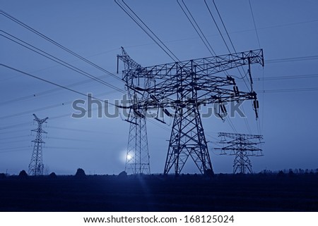 Beautiful high voltage towers under the setting sun exposure