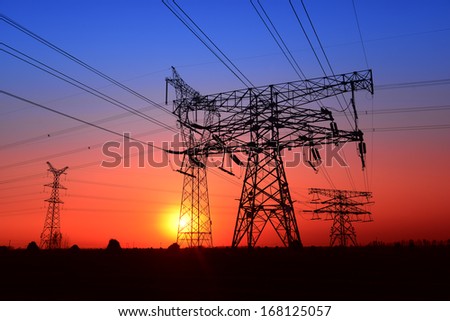Beautiful high voltage towers under the setting sun exposure