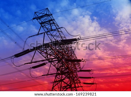 An isolated high voltage towers in the setting sun