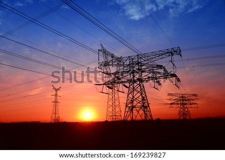 Forms of high voltage towers under the setting sun exposure