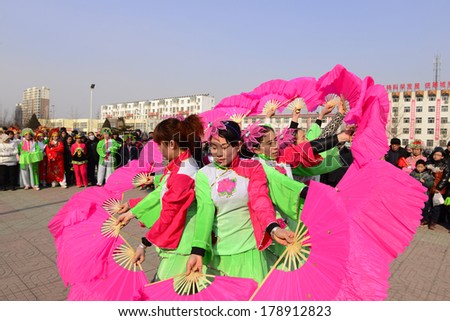 LUANNAN COUNTRY, CHINA - February 11, 2014: people wearing colorful clothes to yangko dance performances in square, hebei province