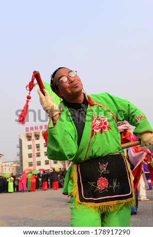 LUANNAN COUNTRY, CHINA - February 13, 2014: people wearing colorful clothes to yangko dance performances in square, hebei province