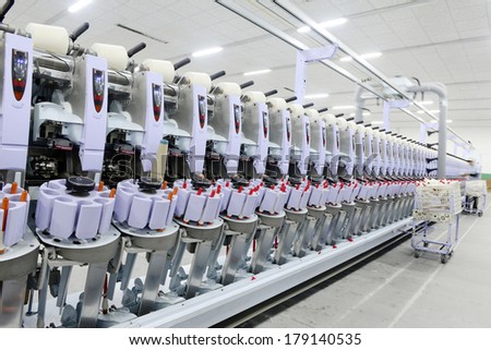 LUANNAN, CHINA - DEC 13: a functioning of spinning equipment is operating within the factory, ze the spinning mill on December 13, 2013, LUANNAN county, hebei province, China.