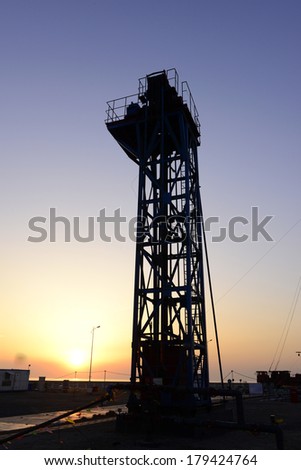 Oil field workers in a tower in pumping unit
