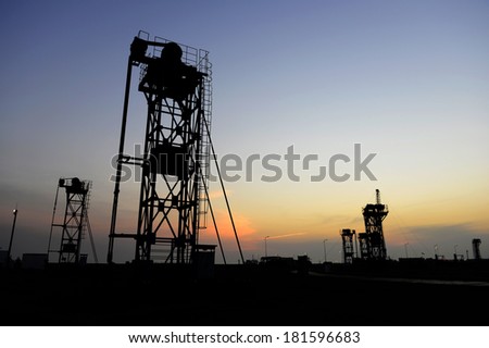 Under the setting sun tower pumping unit work site