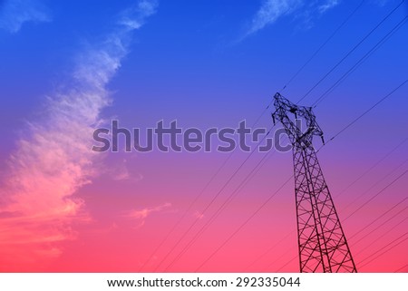 Isolation of high voltage towers under the setting sun, close-up