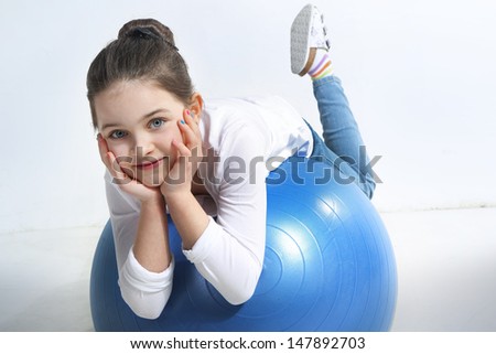 Little girl posing with a a rubber ball