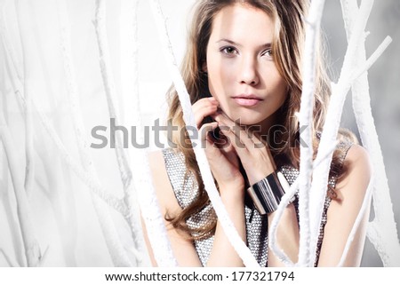 Beautiful delicate woman. Form sensual woman in a silver dress in the fashion stage design