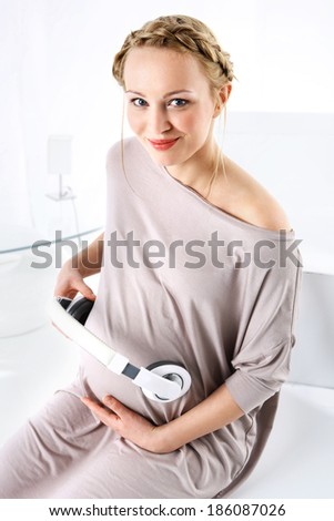 Music in pregnancy. Pregnant woman in advanced pregnancy flying a music unborn child.