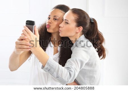 Friends, good news, success .Friendship - friends learn to read message .Two women with mobile phone
