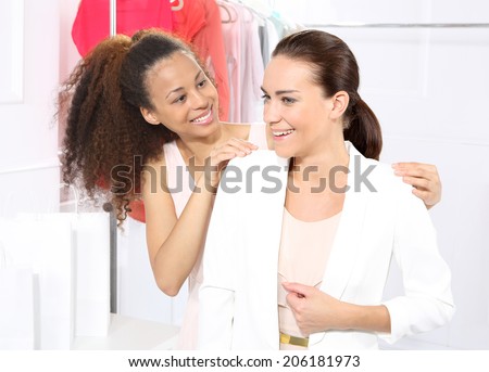 Shopping .Two women shopping in boutique clothing, mulatto and Caucasian
