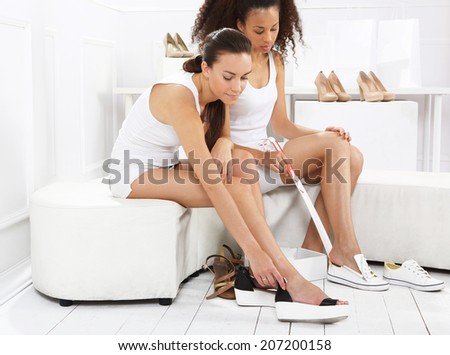 Women buy shoes .Women buy shoes at a shoe store, mulatto and Caucasian