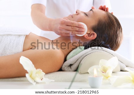Cleansing facial skin a woman in beauty salon Beautiful woman during treatments in the spa salon Cleansing facial skin a woman in beauty salon Beautiful woman during treatments in the spa salon