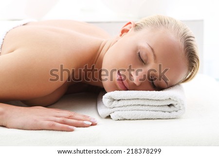 Back massage . Attractive blonde woman in the office spa, relaxes August waiting for a cosmetic procedure.